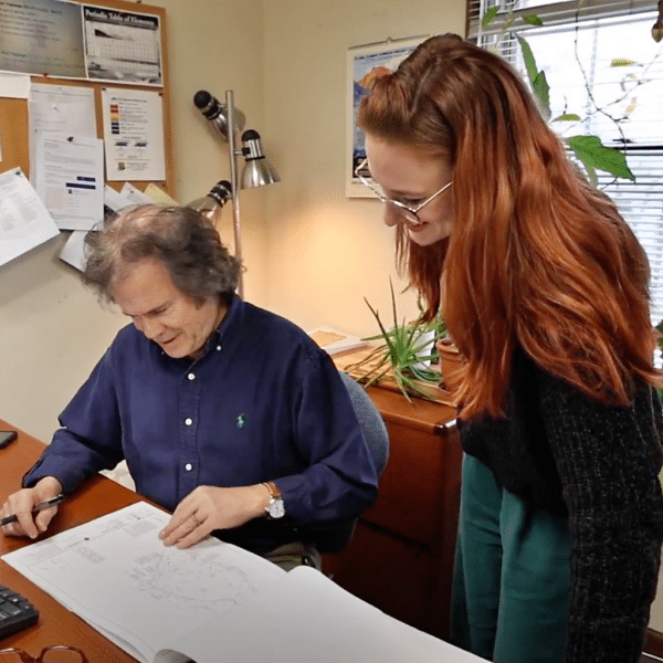 "Experienced engineer mentoring a younger colleague, depicting growth and learning"