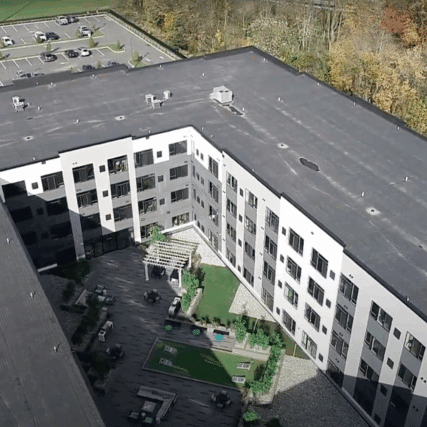 CEC after photo of a previously dilapidated warehouse into a, now, 205-unit luxury apartment building with a swimming pool, underground parking garage, surface parking, and above-ground stormwater facility.