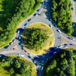 Composite aerial image of traffic using a small roundabout with