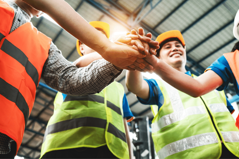 Project team members including civil engineers, architects, and builders working together to build better communities through collaboration